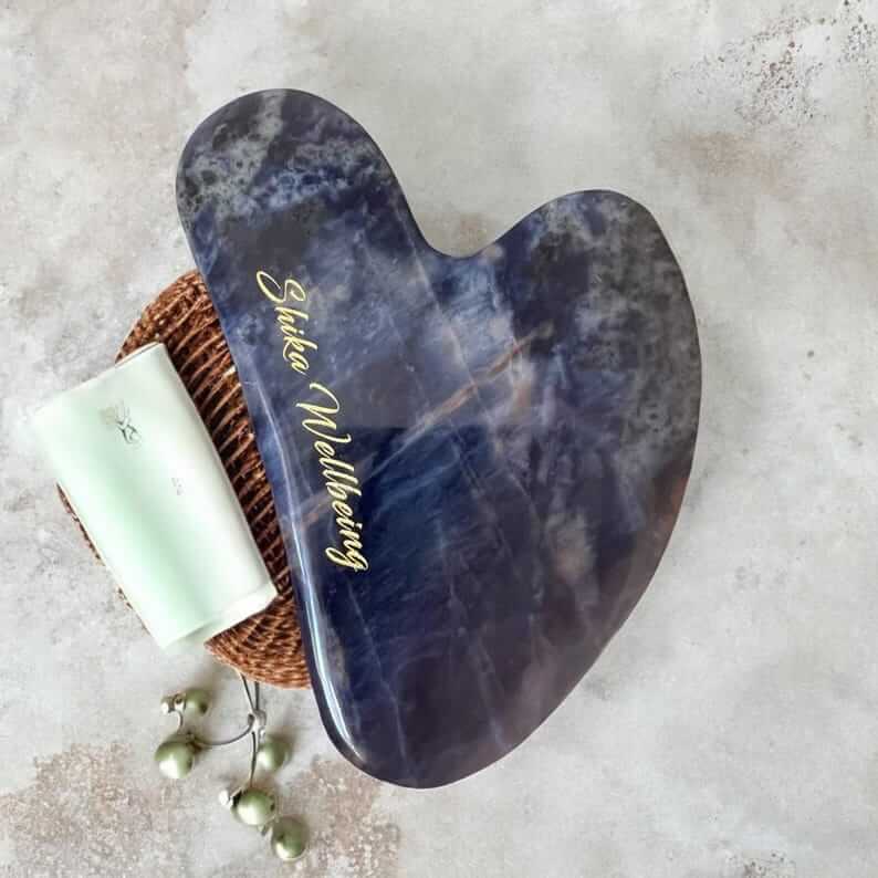 Sodalite Gua Sha Facial Tool on White Background. Close-up of Sodalite Gua Sha Facial Tool