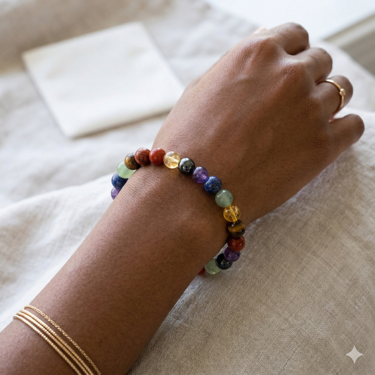 Multicolored beaded bracelet on a wrist with a neutral background