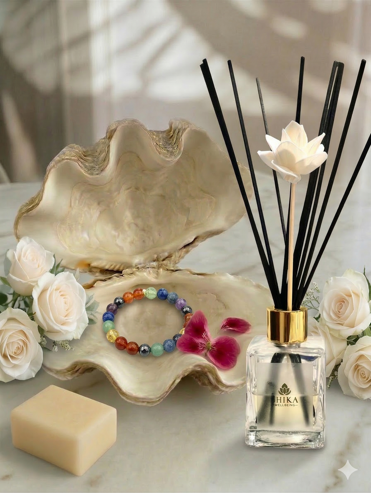 Reed diffuser with flowers and soap on a marble surface
