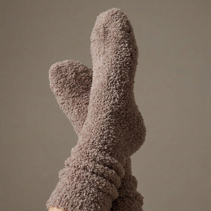 Close-up of fluffy brown socks against a neutral background