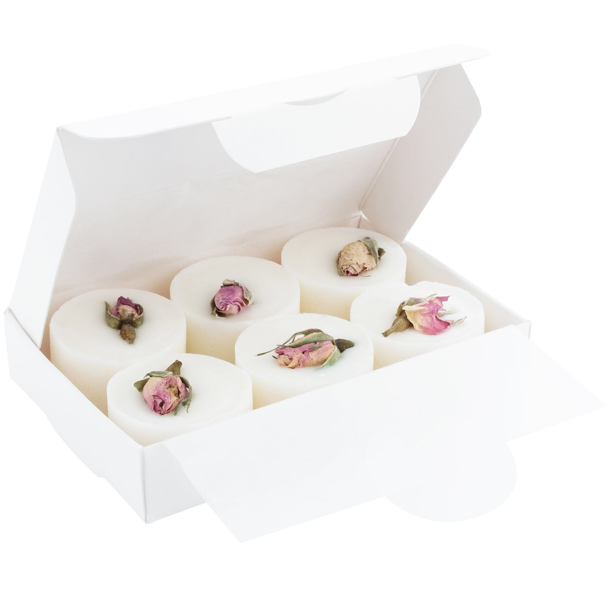 White soap bars with pink flower petals in a white box on a white background