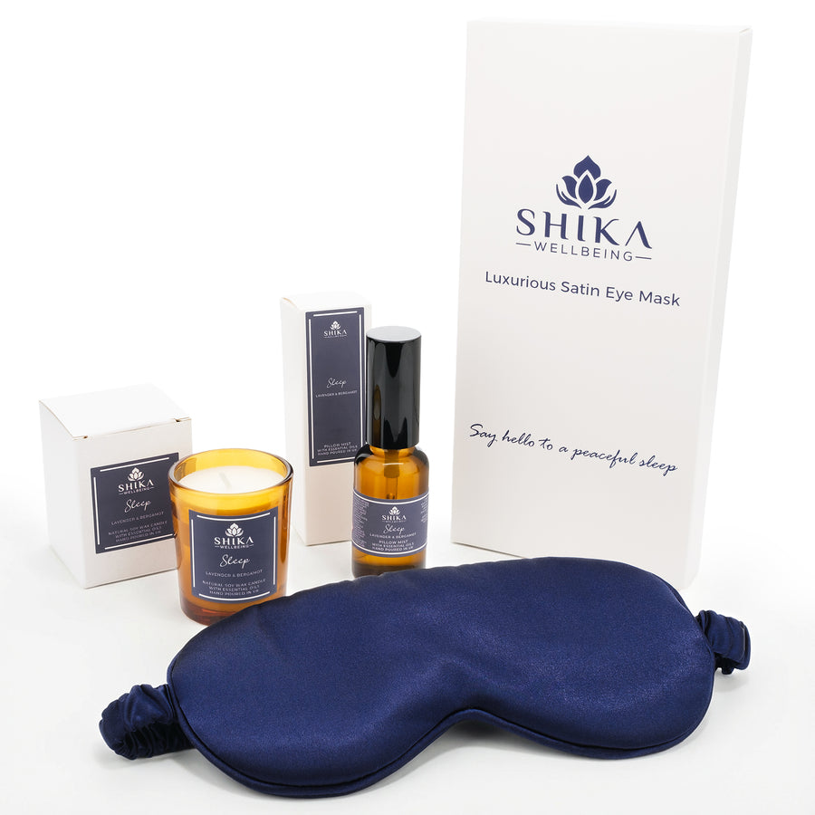 Shika Wellbeing eye mask, candle, and bottle with packaging on a white background