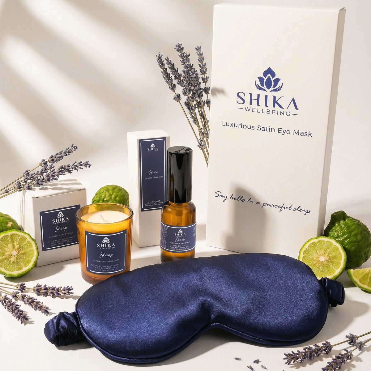 SHIKA Wellbeing satin eye mask with lavender, lime, and essential oil products on a neutral background