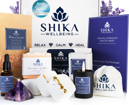 Shika Wellbeing products including candles, soap, and essential oils with branding and product packaging.