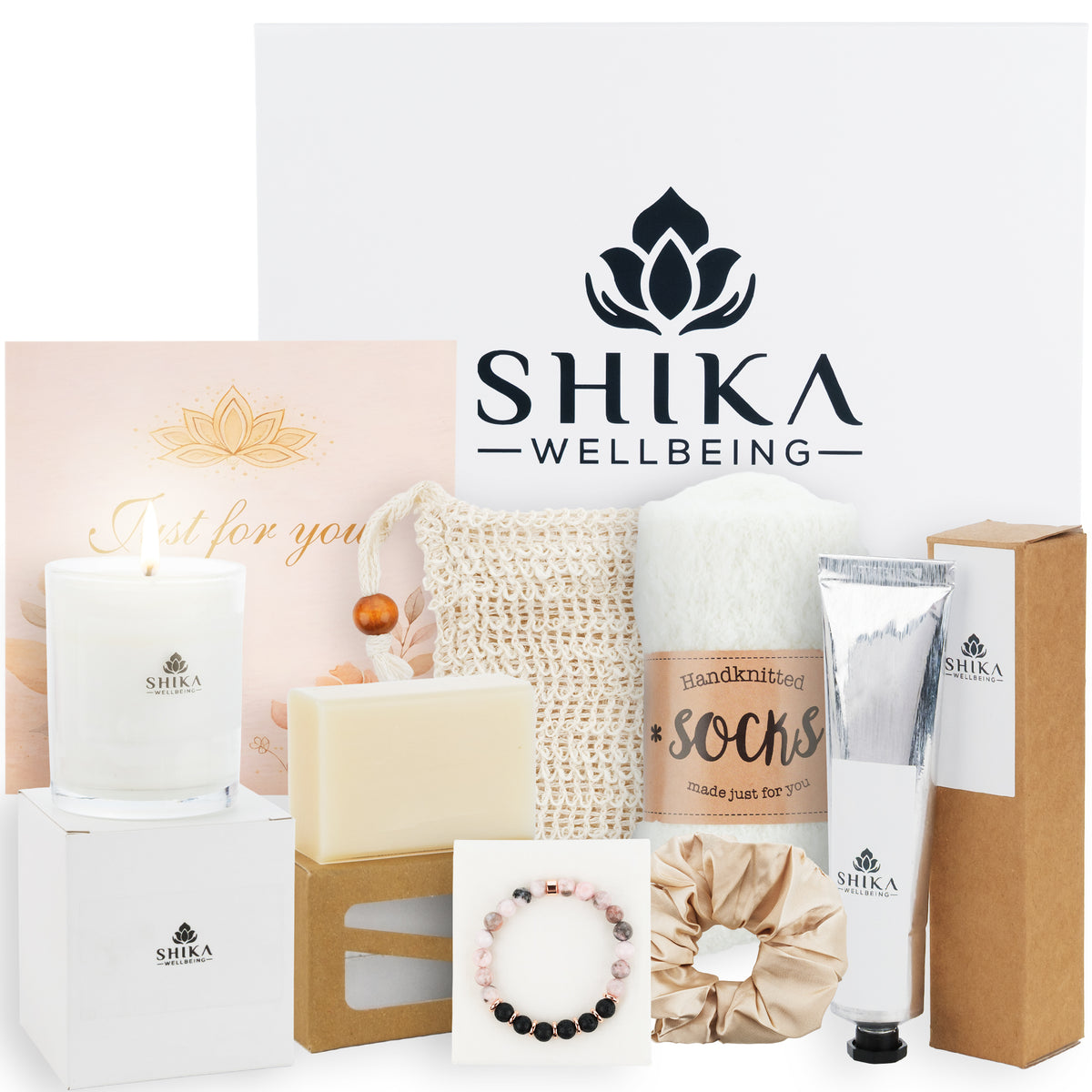 Shika Wellbeing products including candles, soap, and accessories on a white background