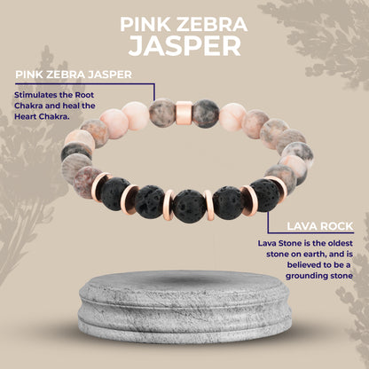 Stones bracelet with pink zebra jasper and lava rock on a gray stand with nature background