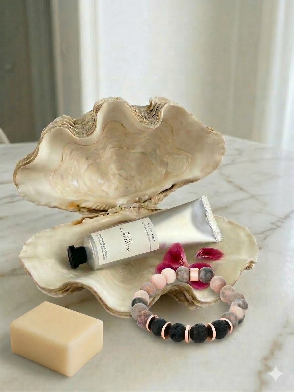 Hand cream, soap, and bracelet on an open shell with a blurred background