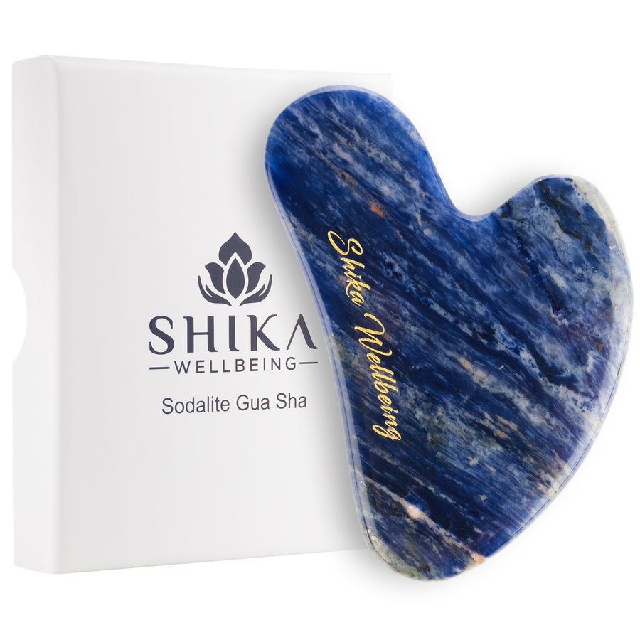 Blue gua sha tool with 'Shika Wellbeing' branding on a white background