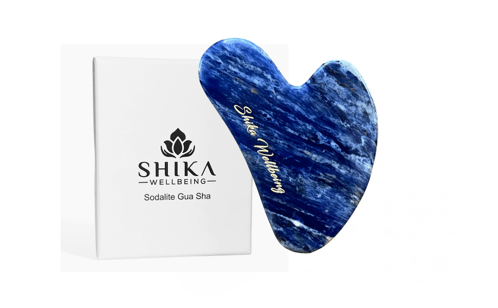 A blue sodalite gua sha facial tool next to its packaging box with 'Shika Wellbeing' branding.