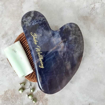 Sodalite Gua Sha Facial Tool on White Background. Close-up of Sodalite Gua Sha Facial Tool