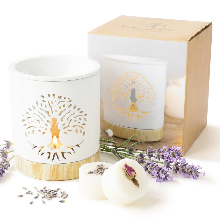 Candle with decorative lid, soap, and lavender flowers on a white background
