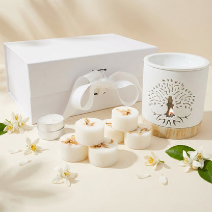 Set of white candles and a decorative lantern with floral design on a beige background
