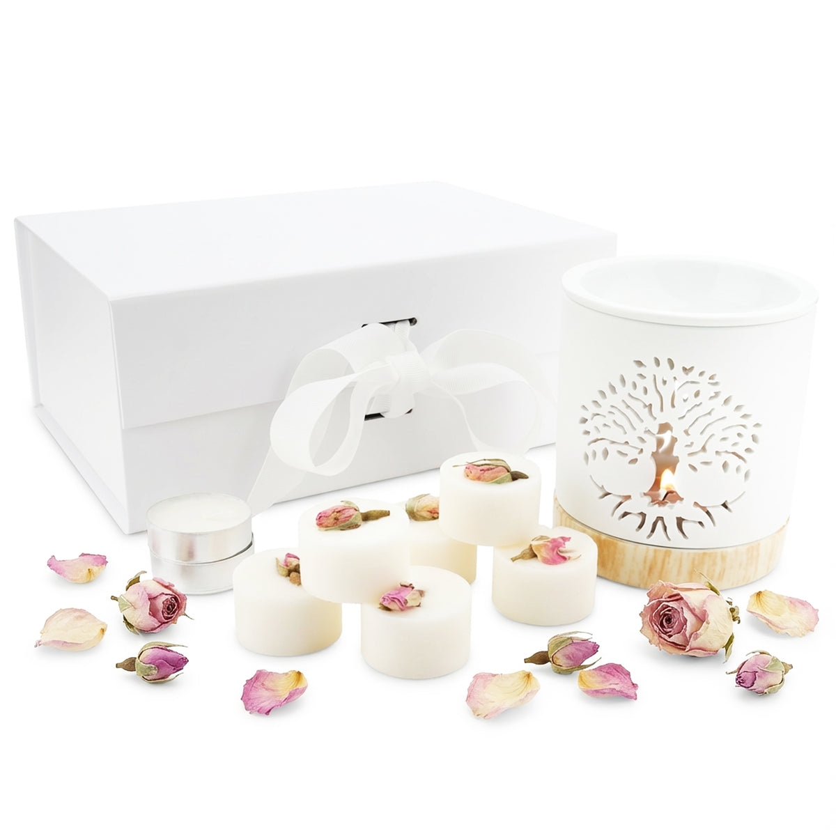 Set of white candles with floral decorations and a decorative bowl on a white background